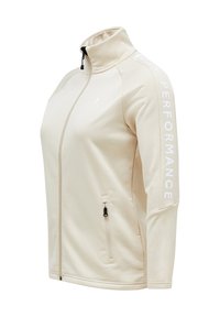 Beige Zip-Jacke mit hohem Kragen, seitlichem Reißverschlussfach und dem Aufdruck 'PERFORMANCE' in Weiß entlang des Ärmels. Glatter, dehnbarer Stoff.