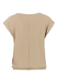 Beige top met korte mouwen, voorzien van een getextureerd cirkelpatroon, losvallend model en een verticale naad in het midden van de rug.
