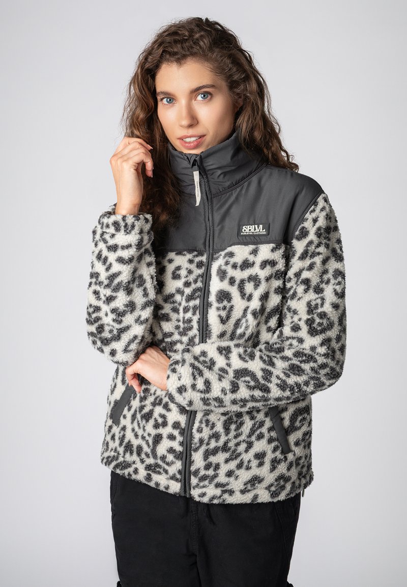 Fuzzy leopard-print jacket in white and gray, featuring a dark gray zippered collar and side pockets, with a smooth fabric upper section.