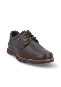 Zapato de cuero marrón con acabado suave, diseño de cordones, cuello acolchado, entresuela de color canela y suela de goma para tracción.