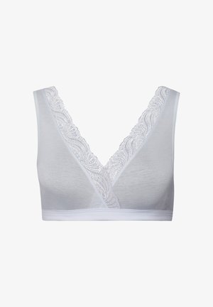Valkoinen bralette, jossa on syvä V-pääntie, ja reunassa on pitsireunus. Valmistettu pehmeästä, joustavasta kankaasta mukavuutta varten.