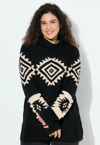 Zwart en crèmekleurig oversized sweater met tribale diamanten patronen, hoge kraag, lange mouwen en duimgaten. Getextureerde breisel stof.