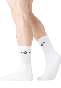 Chaussettes en coton blanc à bord côte, arborant un logo en forme de diamant noir de chaque côté. Douces et respirantes, de longueur standard.