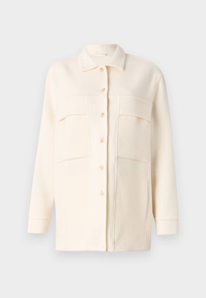 Cream-colored shirt jacket made of soft fabric, featuring a collared neck, button front, and two chest pockets. Long sleeves with cuffs.