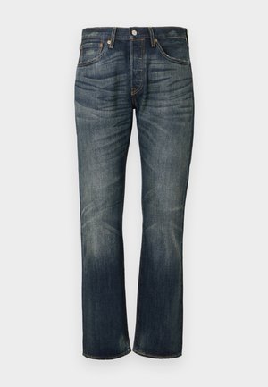 Jeans droit bleu foncé en denim, présentant un design classique à cinq poches, un léger délavage et une fermeture à glissière avec bouton.