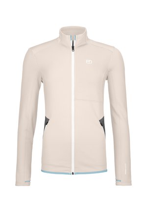 Beige full-zip jacket with high collar, light blue trim, dark gray zippered side pockets, and a white logo on the chest.