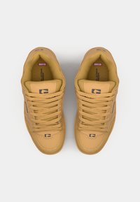 Tan leather sneakers with textured upper, round toe, and flat laces. Features logo on the side and cushioned interior for comfort.