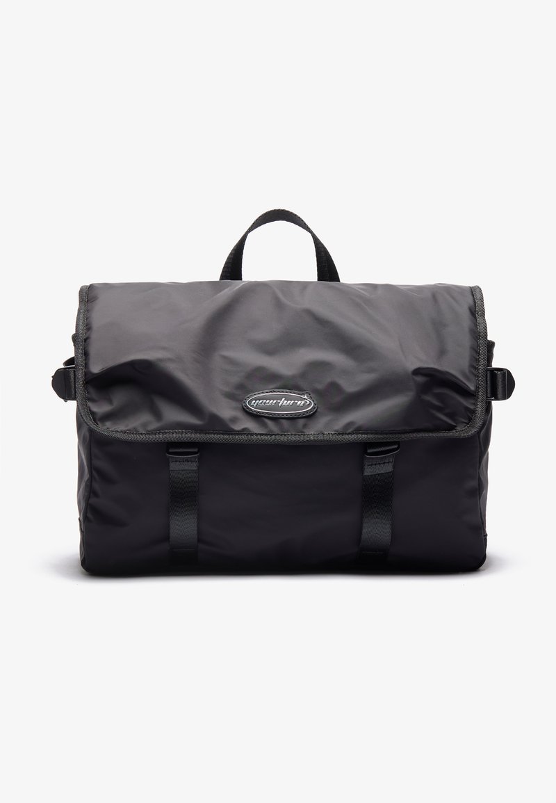 Black nylon messenger bag with a flap closure, top handle, and adjustable straps; features logo and contrasting trim.