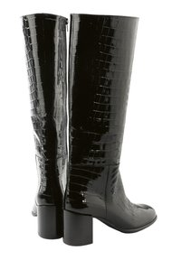 Black patent knee-high boots featuring a croc-embossed design, square toe, chunky heel, and side zip closure. Smooth texture and glossy finish.