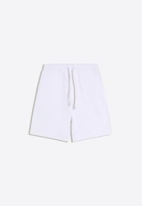 Shorts blancs en coton avec taille élastique et cordon à l'avant, dotés de poches latérales, posés à plat sur un fond uni.