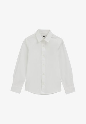 Chemise blanche à manches longues en tissu lisse, dotée d'un col pointu, d'une fermeture à boutons sur le devant et d'un ourlet arrondi. Les boutons sont de couleur claire.