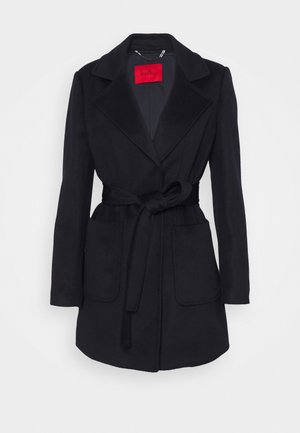 Black belted wool coat with wide lapels and two front patch pockets, displayed against a white background.