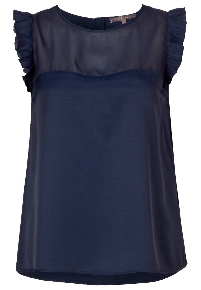 Navy blue blouse made from lightweight fabric, featuring ruffled cap sleeves, a fitted bodice, and a round neckline. Smooth texture.