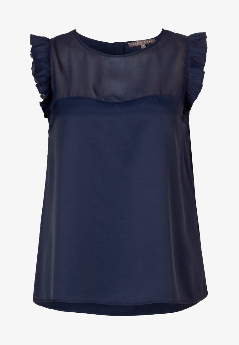 Navy blue blouse made from lightweight fabric, featuring ruffled cap sleeves, a fitted bodice, and a round neckline. Smooth texture.