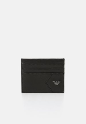 Black leather cardholder featuring multiple card slots, a textured surface, and an embossed logo in the bottom right corner.