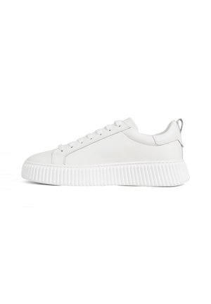 White low-top sneaker with lace-up front and thick, ridged sole, shown in side profile on a white background.