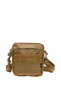 Tan rectangular bag made from durable fabric, featuring a front pocket with Velcro and multiple webbing straps. Adjustable shoulder strap included.