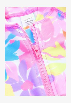 Värikäs kukkakuosiset uima-asu vauvoille, jossa on vaaleanpunainen vetoketju ja kirkkaat kuviot sinisen, keltaisen ja purppuran sävyissä. Pehmeää ja sileää kangasta.