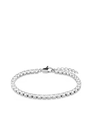 Silver tennis bracelet with clear round stones and a lobster clasp with adjustable chain on a white background.