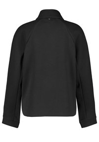 Czarna bluza z kołnierzykiem, raglanowymi rękawami i prostym wykończeniem. Wykonana z miękkiego materiału z ribbowanymi mankietami. Prosty design.