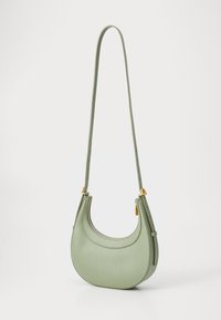 Green leather handbag with a rounded shape, single adjustable strap, and gold hardware accents. Features a zip closure and textured surface.