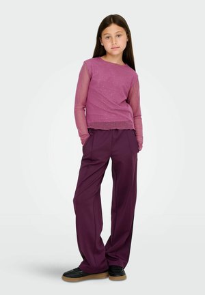 Purple long-sleeve top with sheer mesh sleeves and light embellishments; paired with loose, deep purple trousers and black shoes.