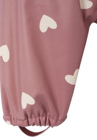 Pink jacket with white heart patterns. Features elastic cuffs and a hanging loop. Made from a smooth, slightly shiny material.