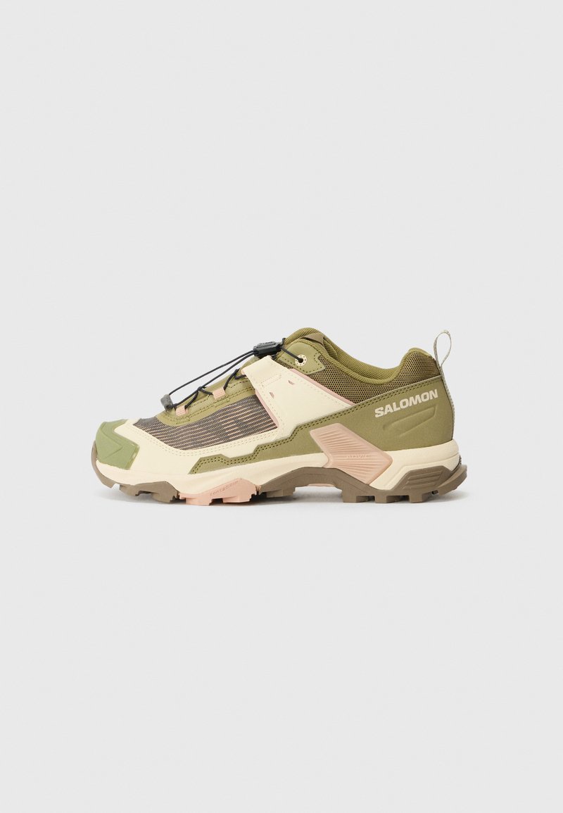 Salomon hiking shoe in olive green and cream, featuring a textured fabric upper, reinforced toe, quick-lace system, and rugged rubber outsole.