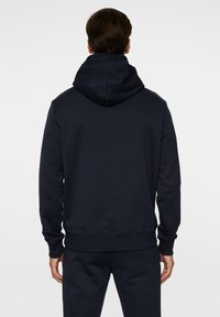 Marineblå hætte sweatshirt med en stor, dobbeltlag hætte, lange �ærmer, ribbede manchetter og kant, lavet af blødt bomuldsblandingsmateriale.