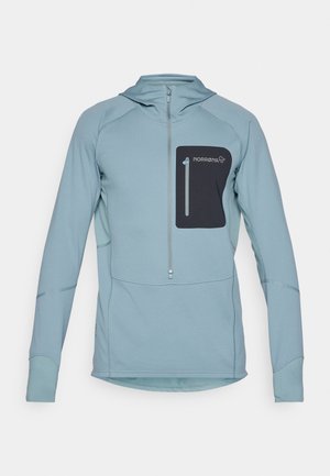 Light blue long-sleeve pullover hoodie with zip closure and a black zippered chest pocket. Made from textured fabric with stitched details.