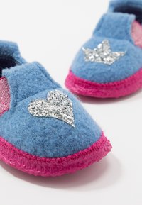 Blue felt slippers with pink rubber soles. Features silver glitter heart and star accents, and mesh side panels for breathability.