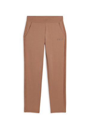 Pantalons de sport beiges avec une texture lisse, une taille élastique et des poches latérales. Présente un branding minimaliste sur la jambe gauche.