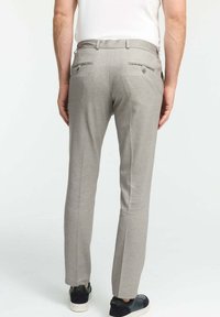 Gray tailored pants with a slim fit, made of textured fabric. Features two back pockets with decorative buttons and a smooth waistband.