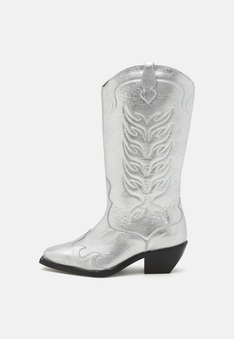 Silver cowboy boot with pointed toe, decorative stitching, and a slightly raised black heel. Made of shiny leather material.