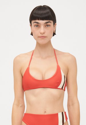 Red bikini top with triangular cups and thin straps, featuring a cream and brown striped accent on one side. Smooth, stretchy fabric.
