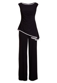 Combinaison noire sans manches avec bordure blanche, haut drapé asymétrique et pantalon à jambes larges.