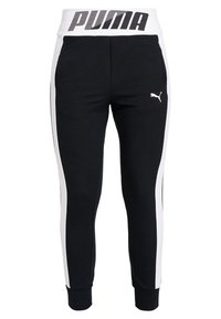 Svarta träningsbyxor med en vit rand längs sidorna, försedd med ett brett vitt midjeband med "PUMA"-logotypen i fet stil.
