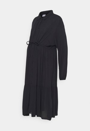 Robe de maternité noire avec manches longues, devant à boutons, ceinture à la taille et jupe à volants. Fabriquée en tissu léger.