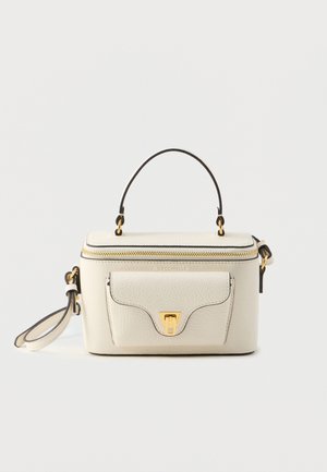 Torba iz kremnega usnja s zgornjim ročajem, z zlatimi kovinskimi dodatki, z zadrgo in sprednjim žepom. Ponaša se s črnim obrobjem in ravnim dnom za stabilnost.