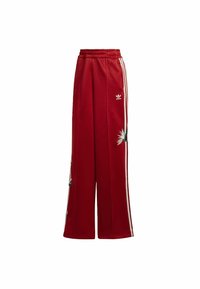 Rode sweatpants met een ontspannen pasvorm, voorzien van witte strepen aan de zijkant en een bloemenborduursel op het linkerbeen. Elastische tailleband voor comfort.