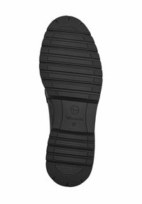Semelle de chaussure en caoutchouc noir avec des rainures horizontales, des zones de grip texturées, et le nom de la marque Tamaris avec la taille 37 embossée au centre.