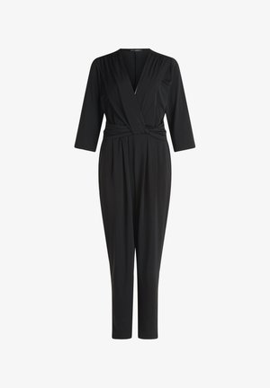 Tuta nera con scollo a V, maniche lunghe, dettagli plissettati sulle spalle e vita con coulisse. Tessuto liscio e elasticizzato, gambe affusolate.