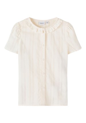 Creamfarvet bluse med korte ærmer, forreste knapper og en lille flæset krave, designet til en småbarn på 2-3 år.