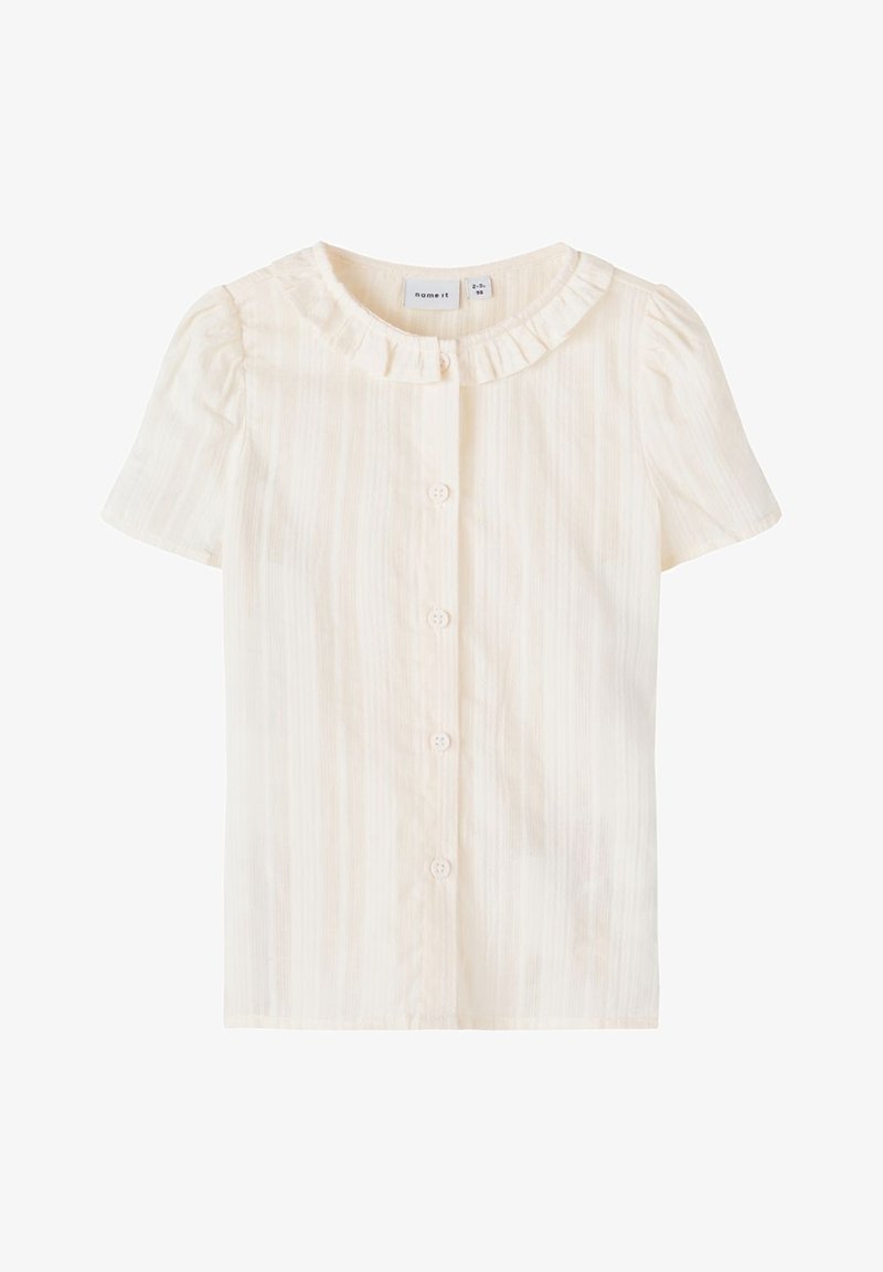 Blouse à manches courtes couleur crème avec boutons sur le devant et petit col à volants, conçue pour un tout-petit de 2 à 3 ans.