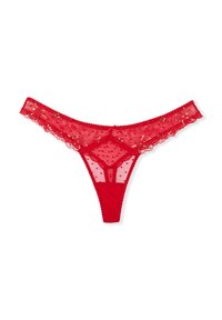 String rouge en dentelle avec une texture à pois, bords festonnés et sequins le long de la taille. Présente un design minimaliste à l'arrière.