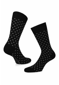 Czarne skarpetki z wzorem małych białych kropek, z ściągaczem i gładką teksturą, zaprojektowane z myślą o komforcie i dopasowaniu.
