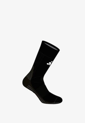 Calcetín deportivo negro con detalles acanalados, logo triangular blanco en la pantorrilla y suela y talón texturizados para agarre y soporte.