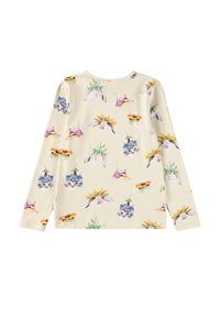 Ilgā piedurkņu krēma krekls ar zīmējumiem, kur attēloti trušu, kaķēnu un pīļu sejiņas, kas valkā krāsainus ziedu cepures, izkaisīti pa audumu.