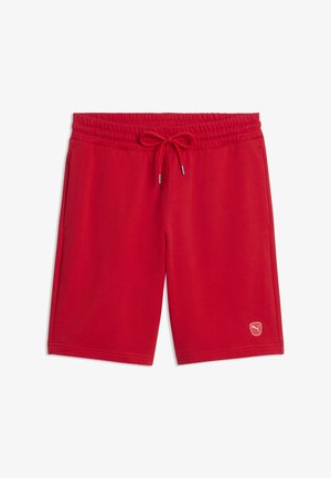 Shorts de sport rouges avec taille élastique et cordon de serrage, poches latérales, et petit logo Puma sur l'ourlet de la jambe gauche.
