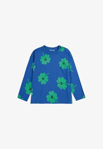 Blue long-sleeve T-shirt featuring a repetitive green clover print with black accents, made from soft cotton material.